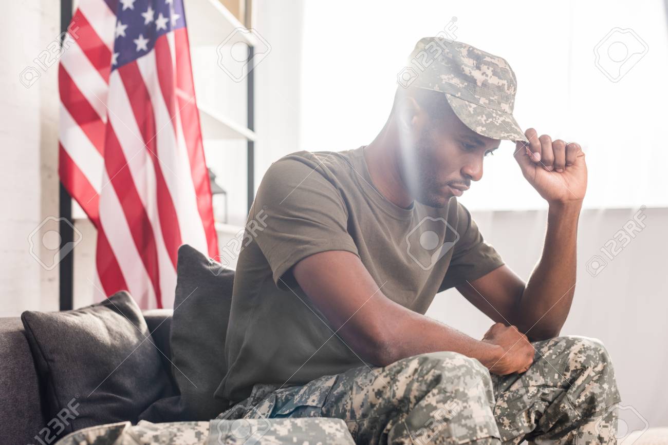 African american soldier in camouflage clothes sitting on sofa - 106750102 African american soldier in camouflage clothes sitting on sofa - 106750102