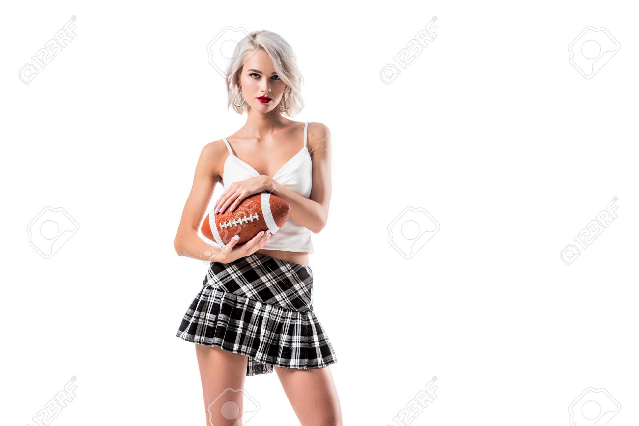 portrait of attractive blond woman in short plaid skirt holding rugby ball isolated on white - 109832462 portrait of attractive blond woman in short plaid skirt holding rugby ball isolated on white - 109832462