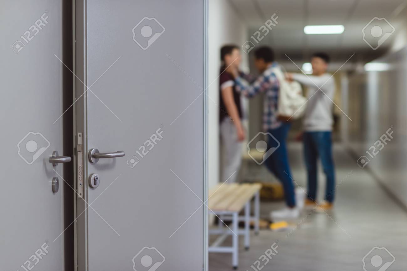 Blurred shot of schoolboy being bullied by classmates in school corridor - 110825818 Blurred shot of schoolboy being bullied by classmates in school corridor - 110825818