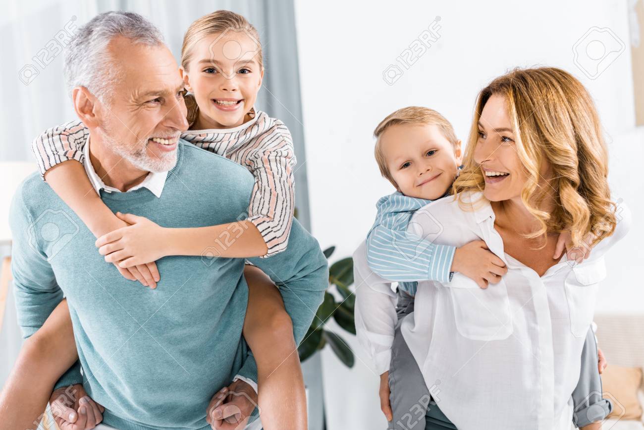 laughing grandparents doing piggyback ride to adorable grandchildren at home - 112334212 laughing grandparents doing piggyback ride to adorable grandchildren at home - 112334212