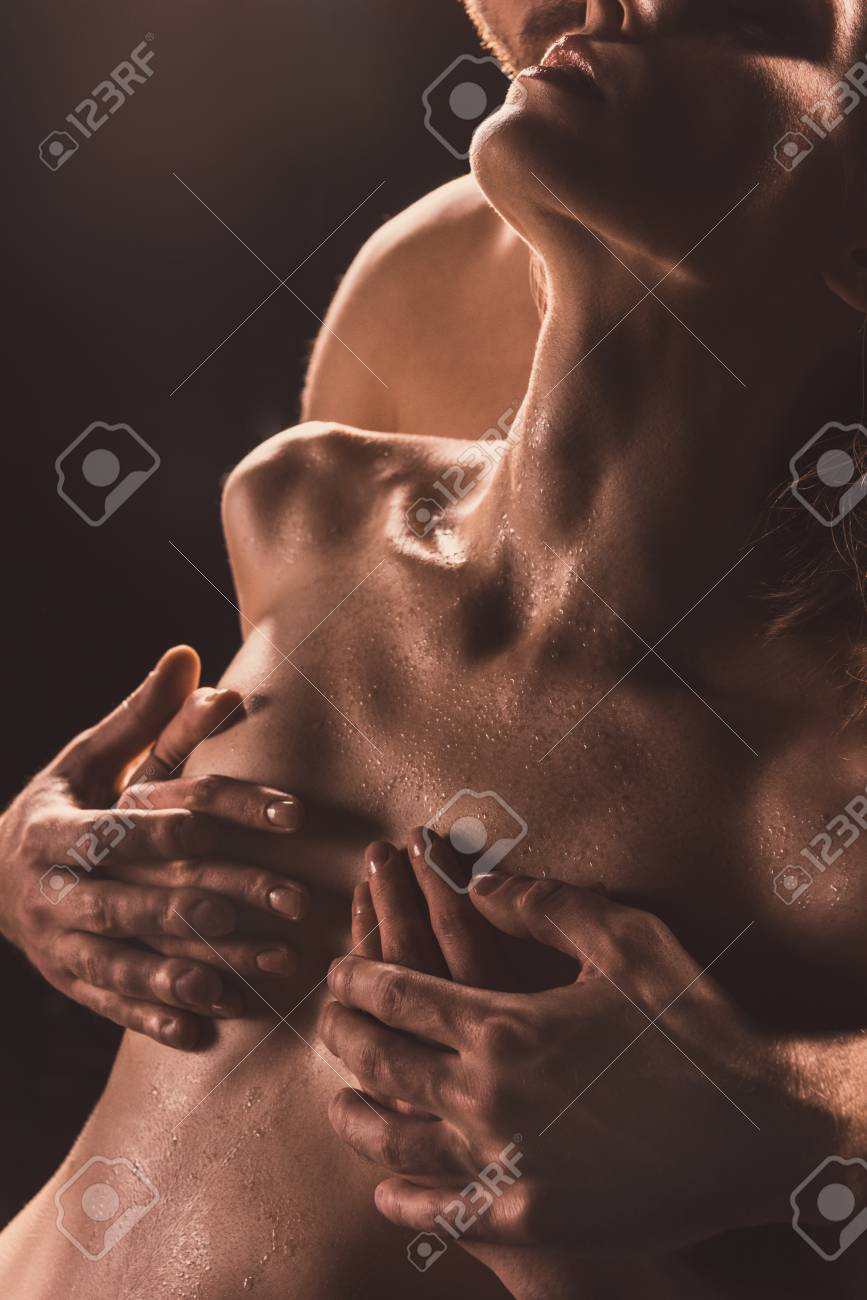 Cropped View Of Boyfriend Touching Breast Of His Naked Girlfriend, On Brown Stock Photo, Picture and Royalty Free Image