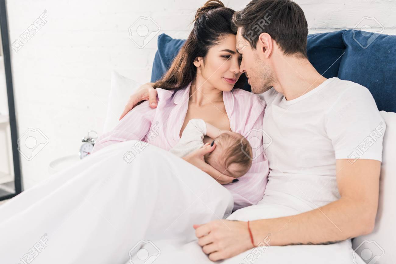 breastfeeding baby and husband