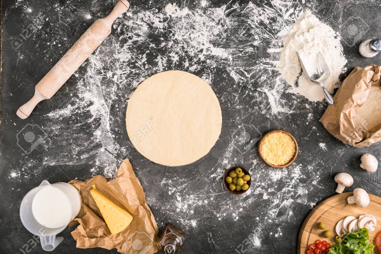 Top View Of Pizza Dough With Ingredients On Grey Background Stock Photo Picture And Royalty Free Image Image 117868327