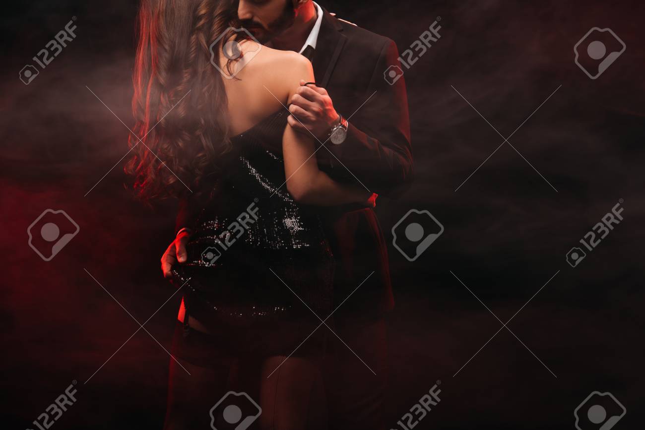 cropped view of passionate couple hugging in red smoky room - 118504579 cropped view of passionate couple hugging in red smoky room - 118504579