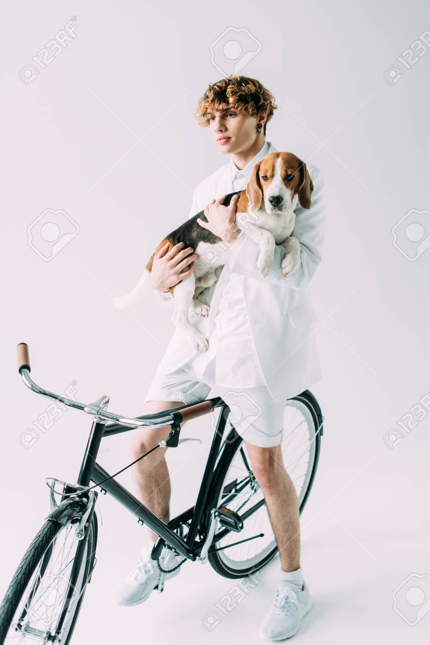 Handsome Man With Curly Hair Holding In Arms Beagle Dog While
