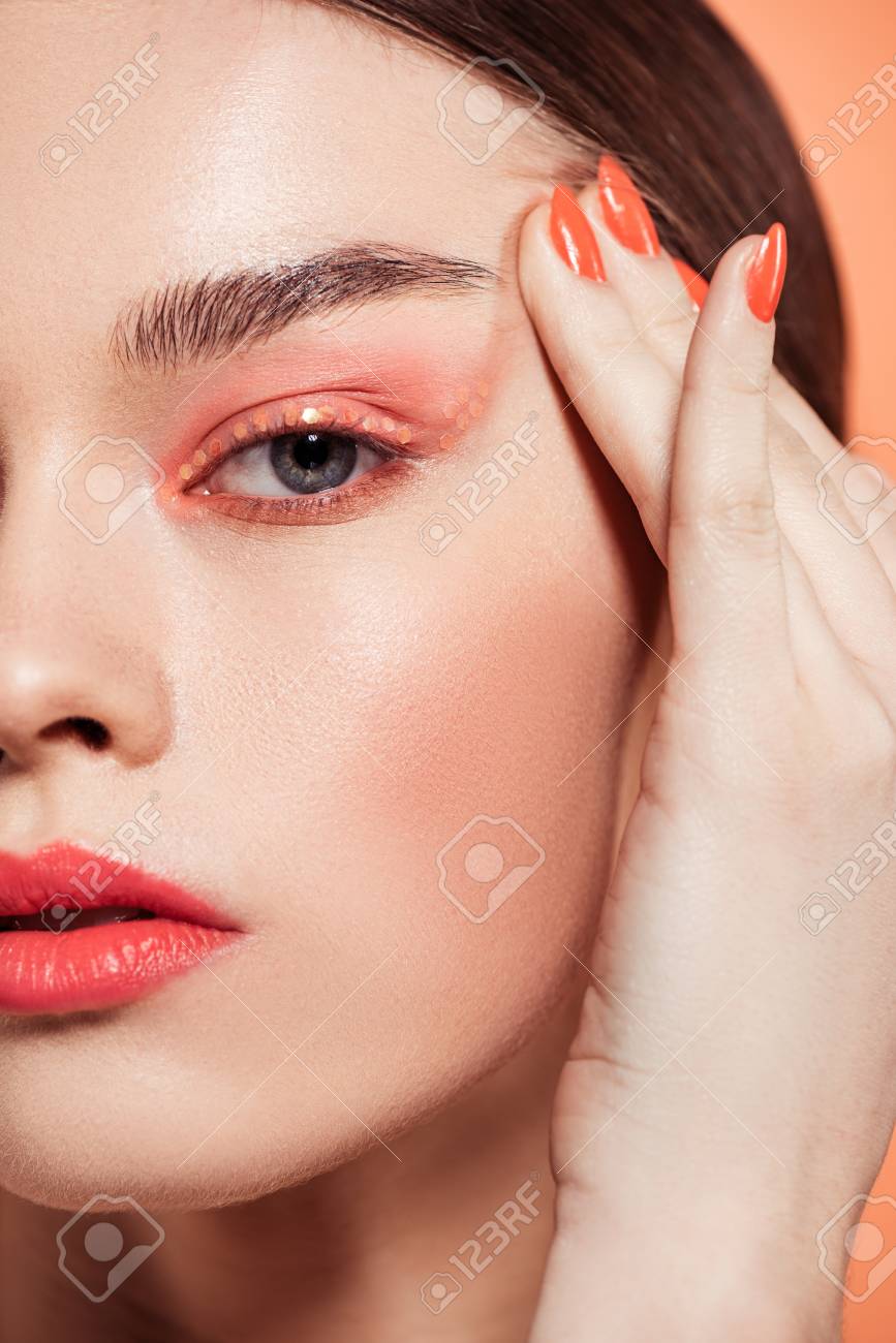 beautiful stylish young woman with glitter makeup looking at camera isolated on coral - 119041932 beautiful stylish young woman with glitter makeup looking at camera isolated on coral - 119041932