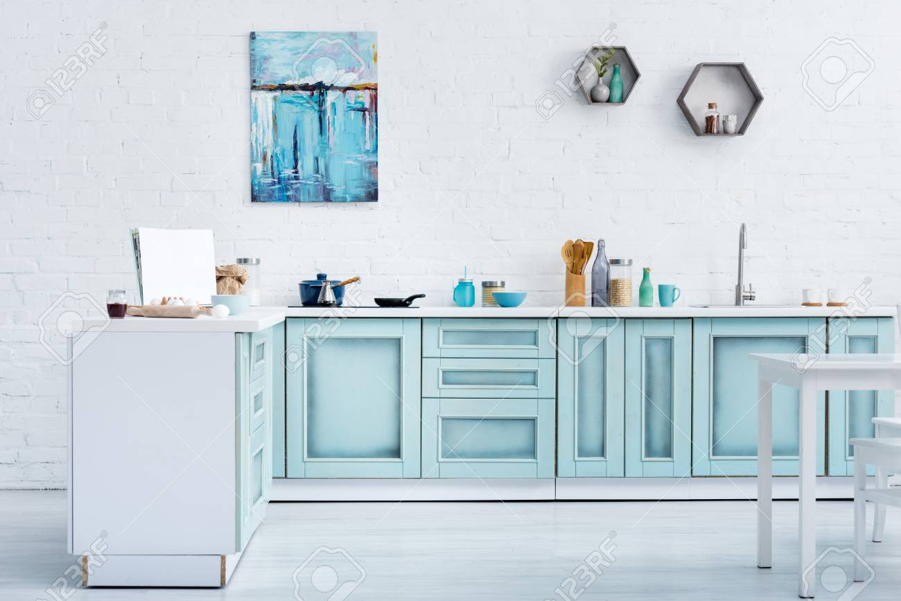 Interior Of Modern Bright Turquoise Kitchen With Painting On
