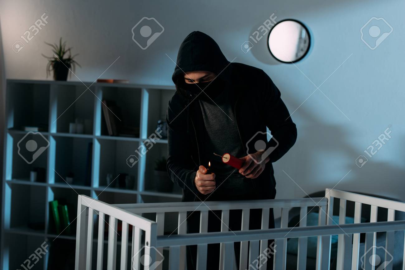 Criminal In Mask Igniting Dynamite Near Crib In Dark Room