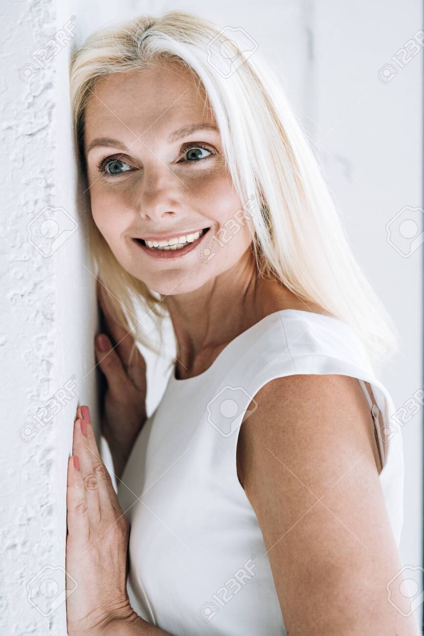 Happy Blonde Mature Woman With Hands On