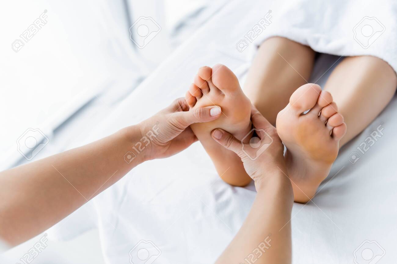 cropped view of masseur doing foot massage to woman in spa - 132166593 cropped view of masseur doing foot massage to woman in spa - 132166593