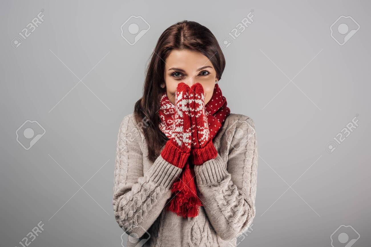 woman in red gloves and scarf covering face isolated on grey - 133839225 woman in red gloves and scarf covering face isolated on grey - 133839225