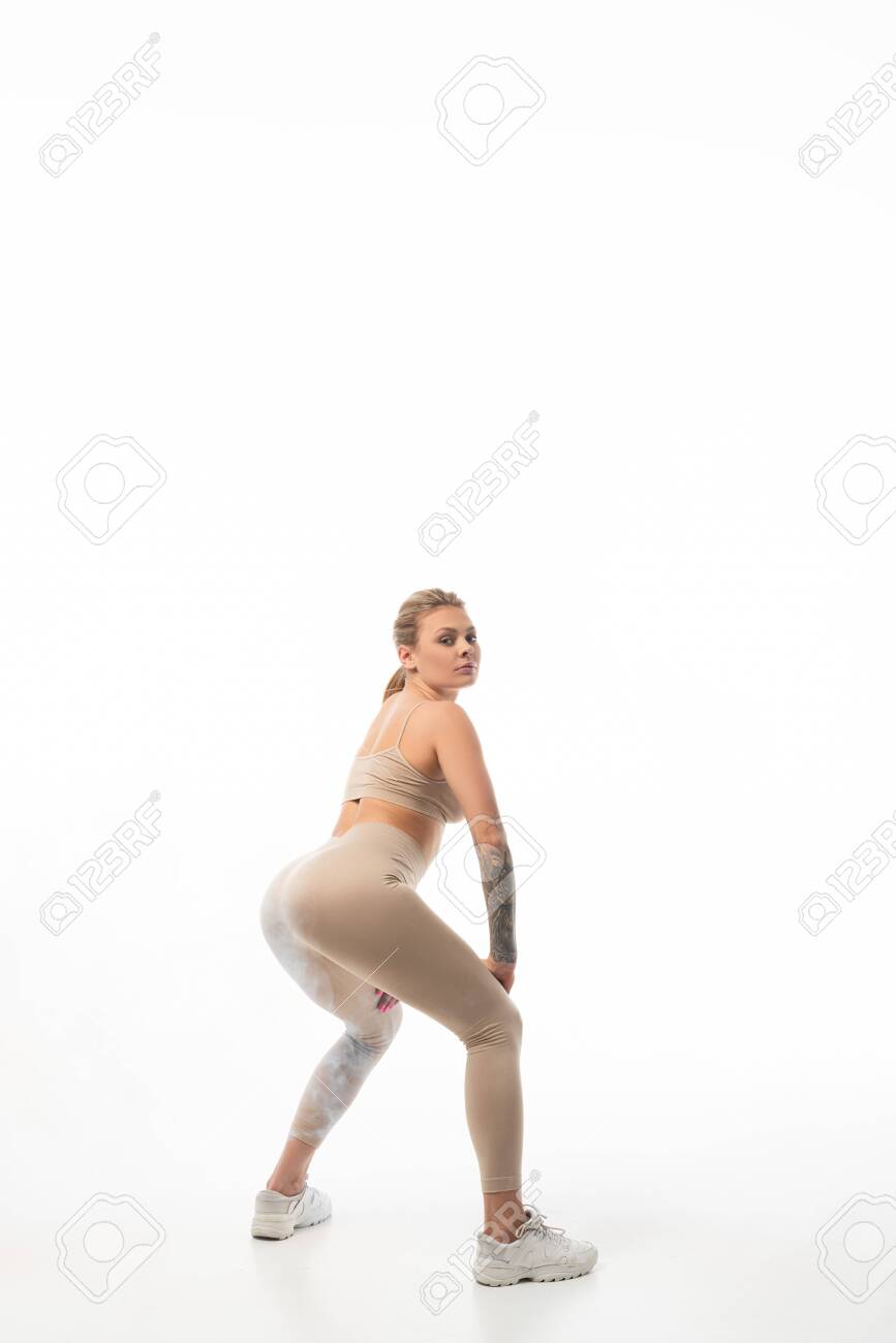 Young Sexy Blonde Girl In Beige Leggings Twerking Isolated On White Stock  Photo, Picture and Royalty Free Image. Image 135687535.