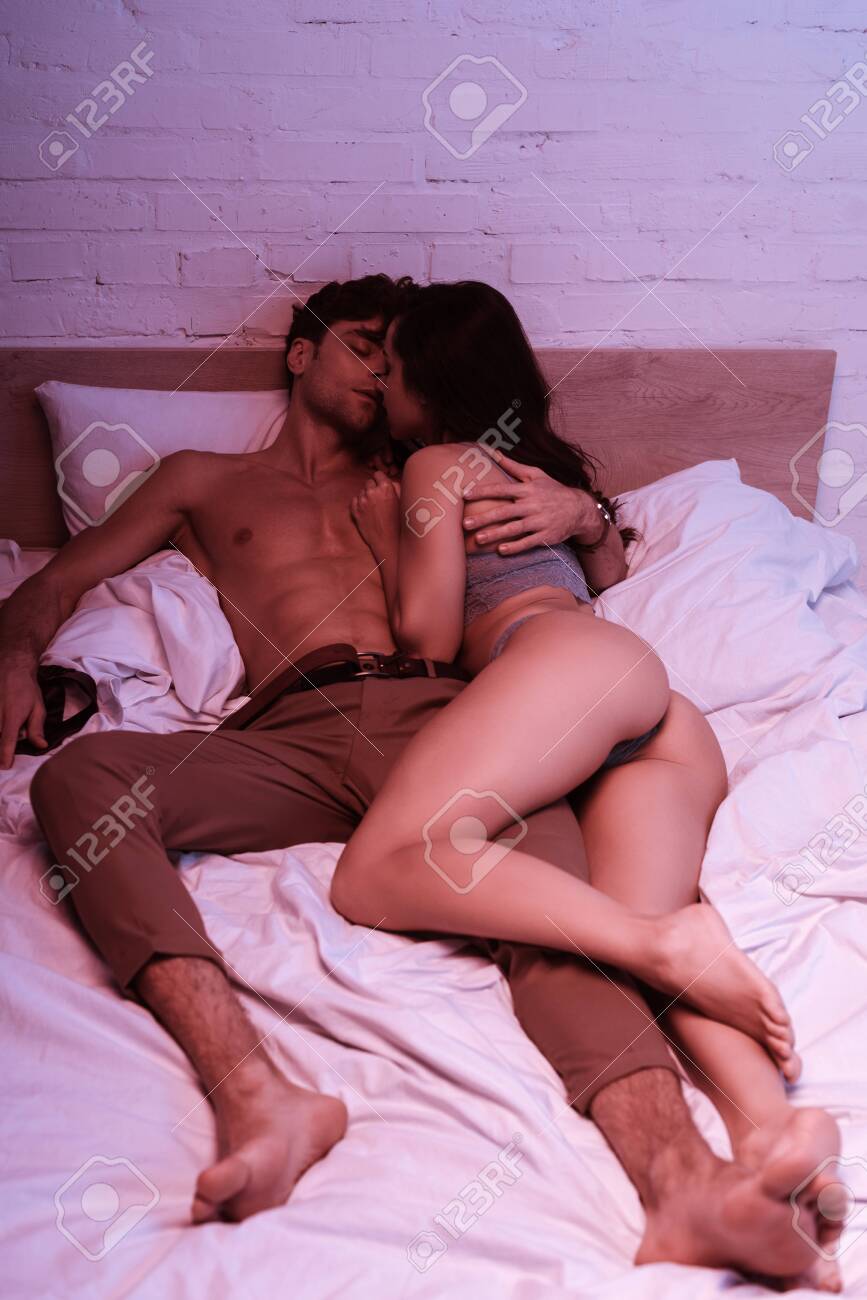 Passionate Girl In Lingerie Kissing Sexy Boyfriend In Bed Stock Photo,  Picture and Royalty Free Image. Image 135700983.