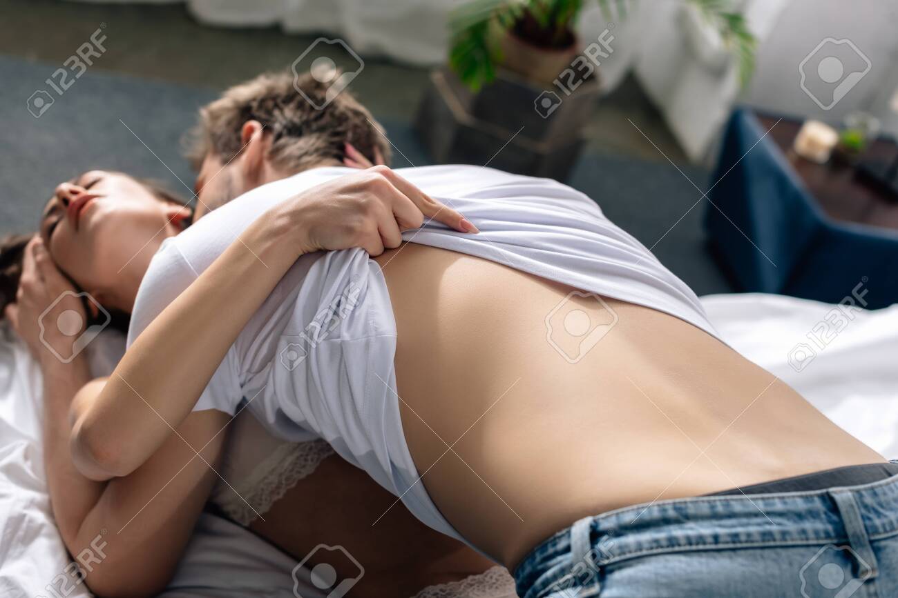 Selective Focus Of Girlfriend Undressing Boyfriend And He Kissing Her Stock  Photo, Picture and Royalty Free Image. Image 140555123.