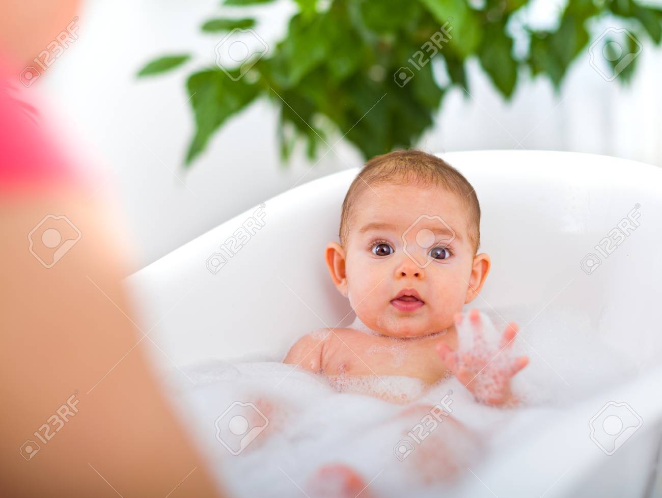 Cute Baby Bathing With The Help Of The 