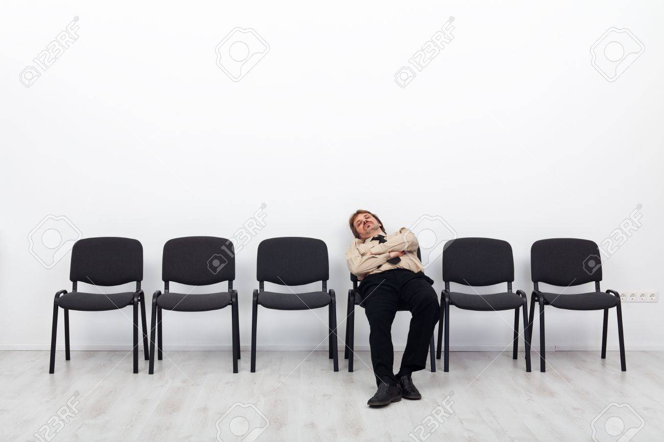 Tired businessman waiting - sitting on a chairs row - 17370158 Tired businessman waiting - sitting on a chairs row - 17370158