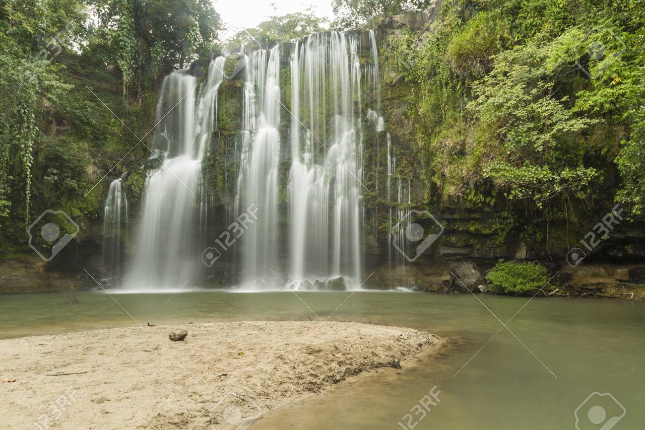 A sandy beach at a popular swimming hole at Llanos de Cortés waterfall near Bagaces, Costa Rica - 34829338 A sandy beach at a popular swimming hole at Llanos de Cortés waterfall near Bagaces, Costa Rica - 34829338