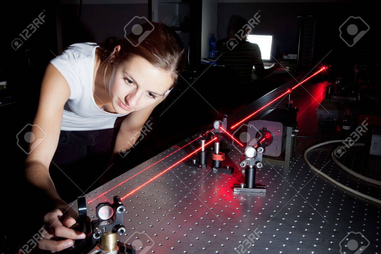 female scientist doing research in a quantum optics lab - 10575899 female scientist doing research in a quantum optics lab - 10575899