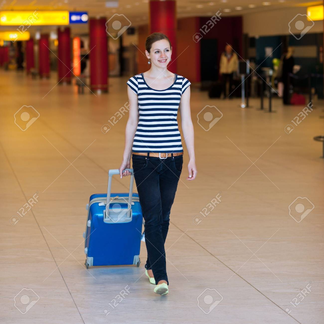 Pretty young female passenger at the airport (shallow DOF; color toned image) - 11303470 Pretty young female passenger at the airport (shallow DOF; color toned image) - 11303470