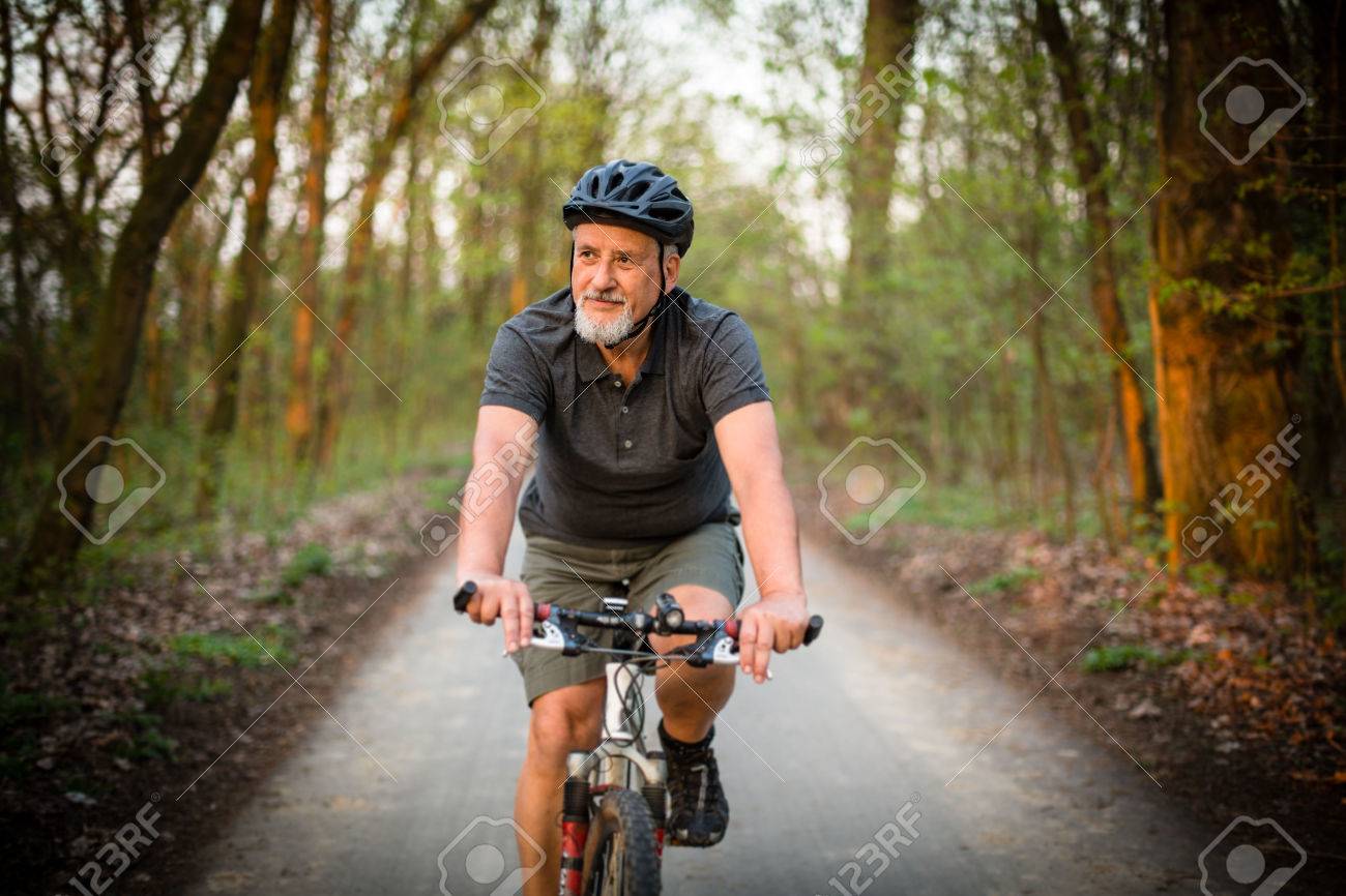 Senior man on his mountain bike outdoors (shallow DOF; color toned image) - 54568373 Senior man on his mountain bike outdoors (shallow DOF; color toned image) - 54568373