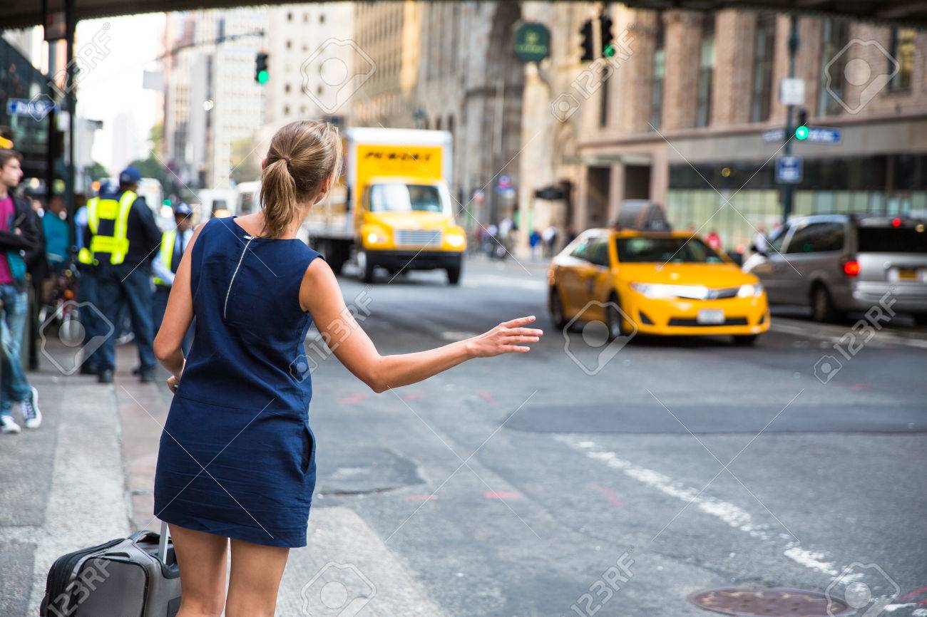 Girl calling/hailking taxi cab on Manhattan, New York City, USA - 60593144 Girl calling/hailking taxi cab on Manhattan, New York City, USA - 60593144