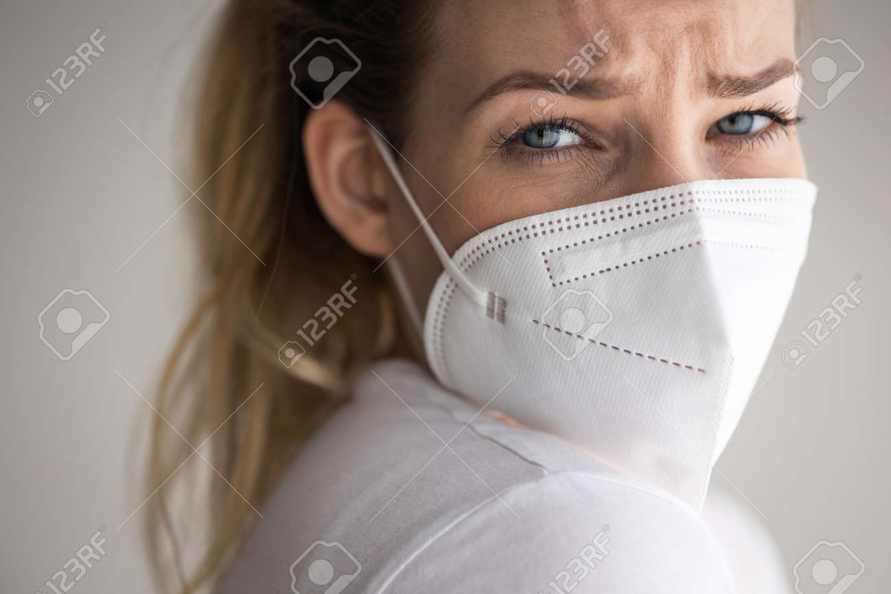Young woman wearing a face mask during coronavirus and flu outbreak. - 169294165 Young woman wearing a face mask during coronavirus and flu outbreak. - 169294165