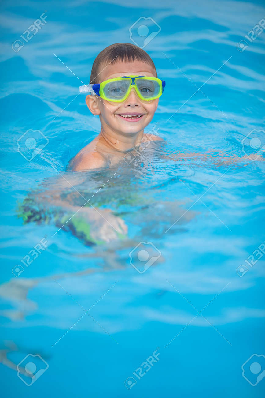 Cute little boy in a swimming pool - 171623537 Cute little boy in a swimming pool - 171623537