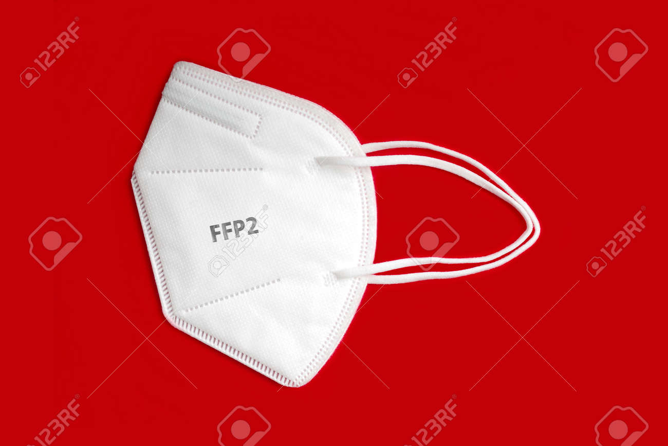 Side view of FFP 2 n95 protective face mask isolated on red background. - 163281517 Side view of FFP 2 n95 protective face mask isolated on red background. - 163281517