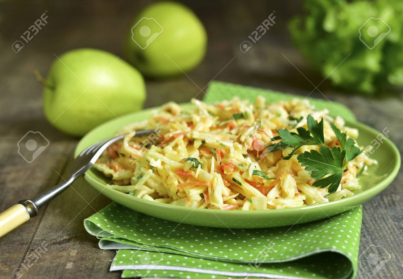 Coleslaw with apple on a green plate on ruatic background. - 58468575 Coleslaw with apple on a green plate on ruatic background. - 58468575