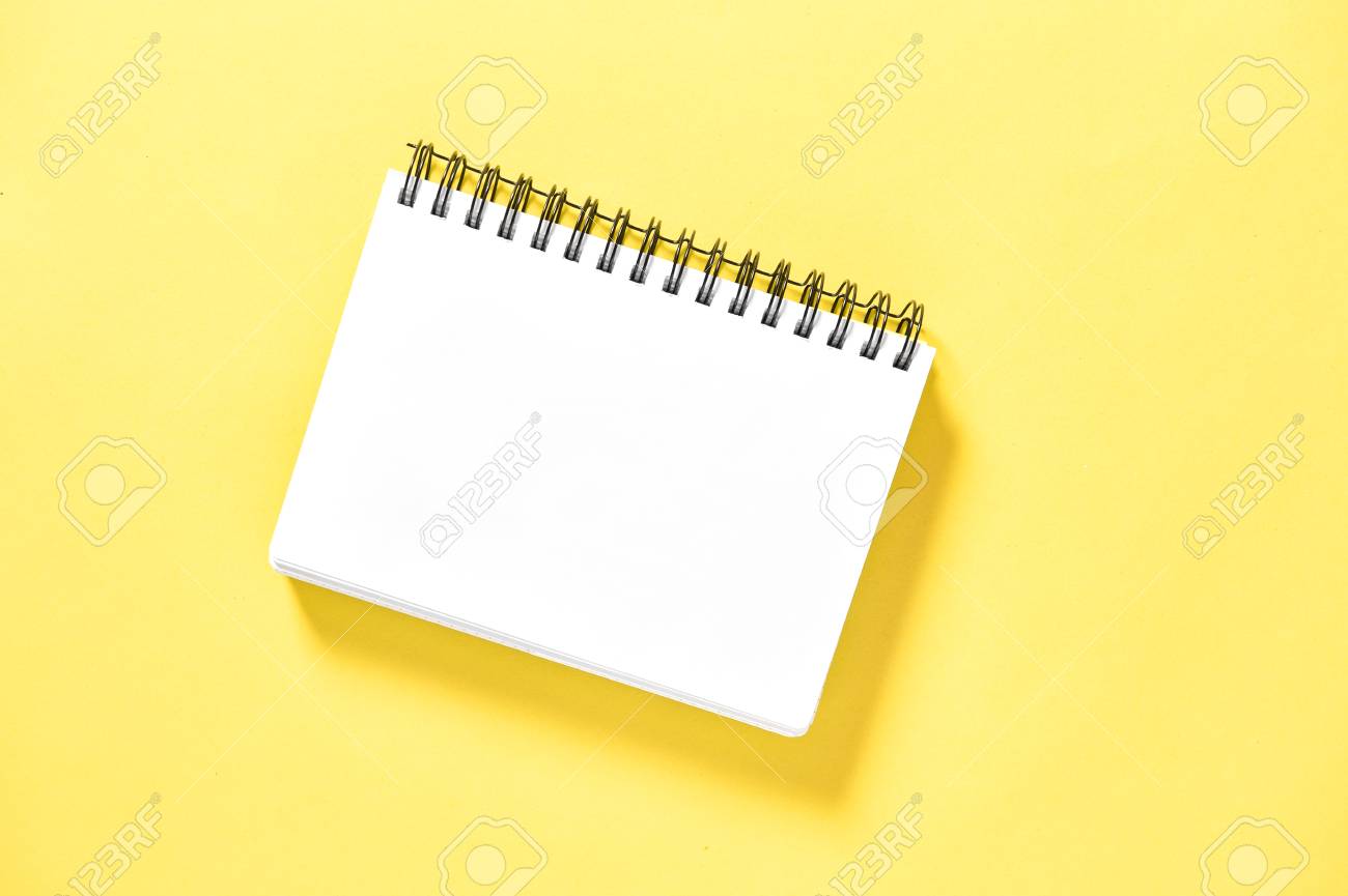 spiral book on yellow background paper notebook stock photo