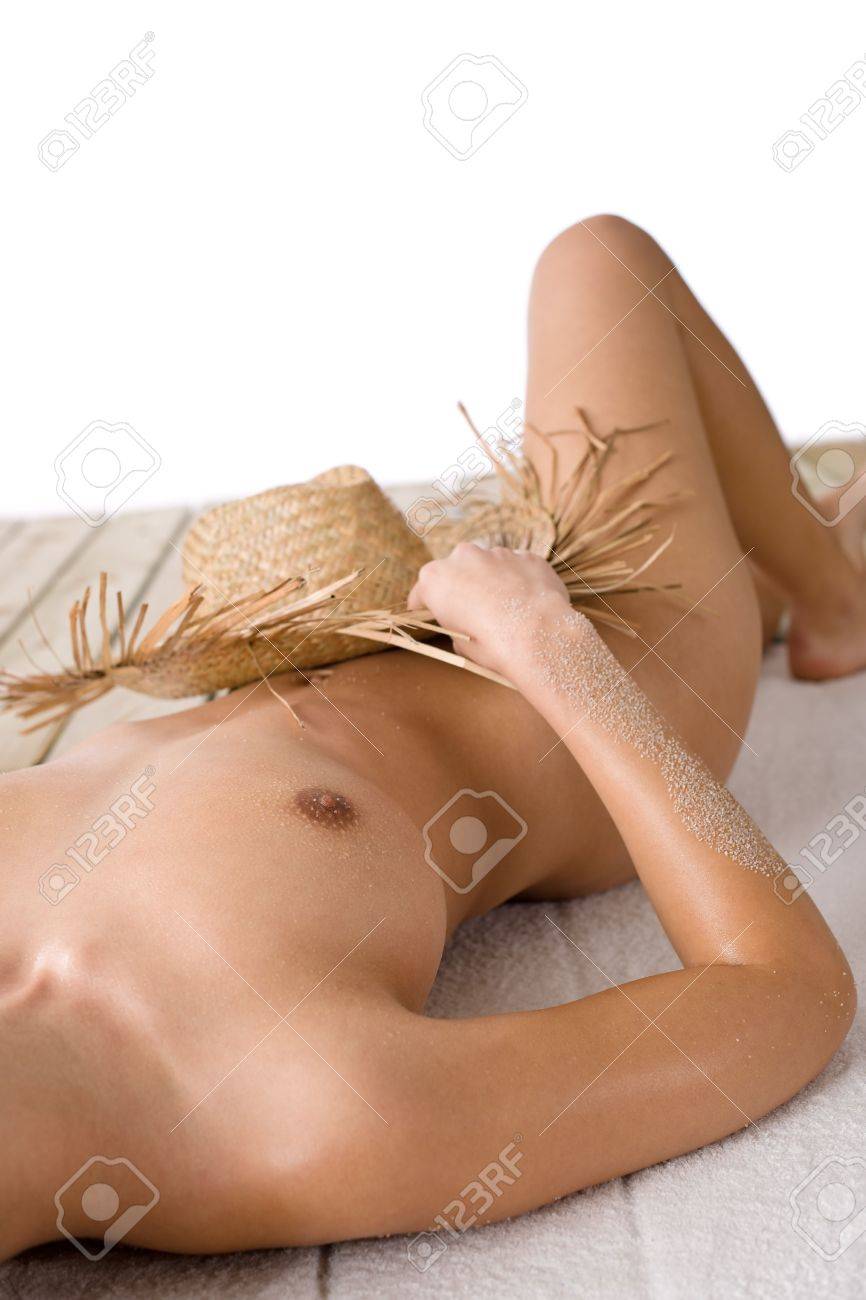 Naked Woman Sunbathing On Beach With Straw Hat Lying Down Stock Photo, Picture And Royalty Free Image