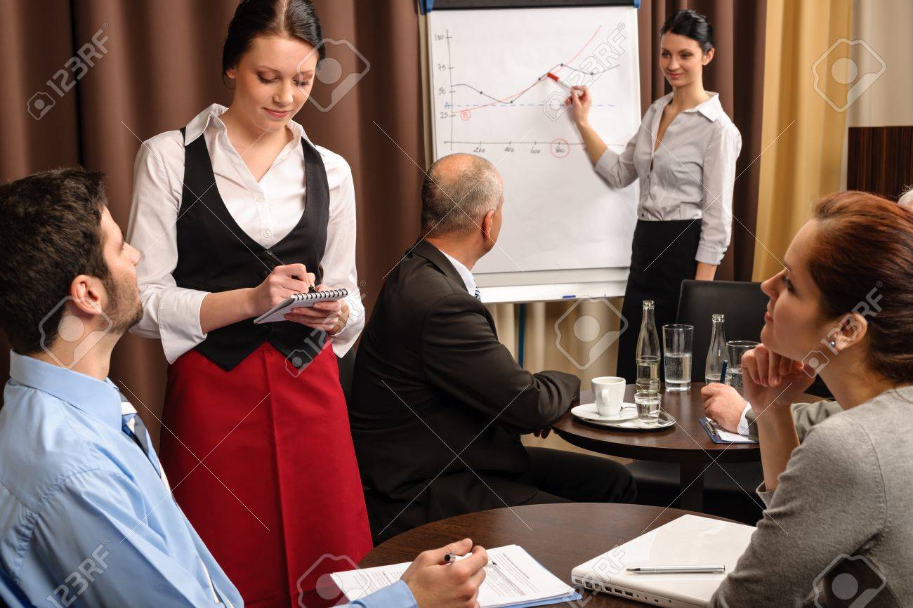 waitress take order people at business meeting flipchart