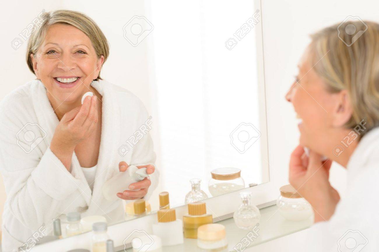 Bathroom Mirror Removal senior woman smiling cleaning face make-up removal bathroom mirror Bathroom Mirror Removal senior woman smiling cleaning face make-up removal bathroom mirror
