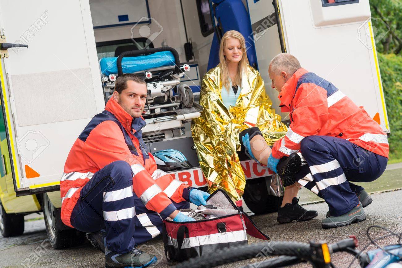 Bike accident woman emergency doctor checking leg in ambulance - 15412680 Bike accident woman emergency doctor checking leg in ambulance - 15412680