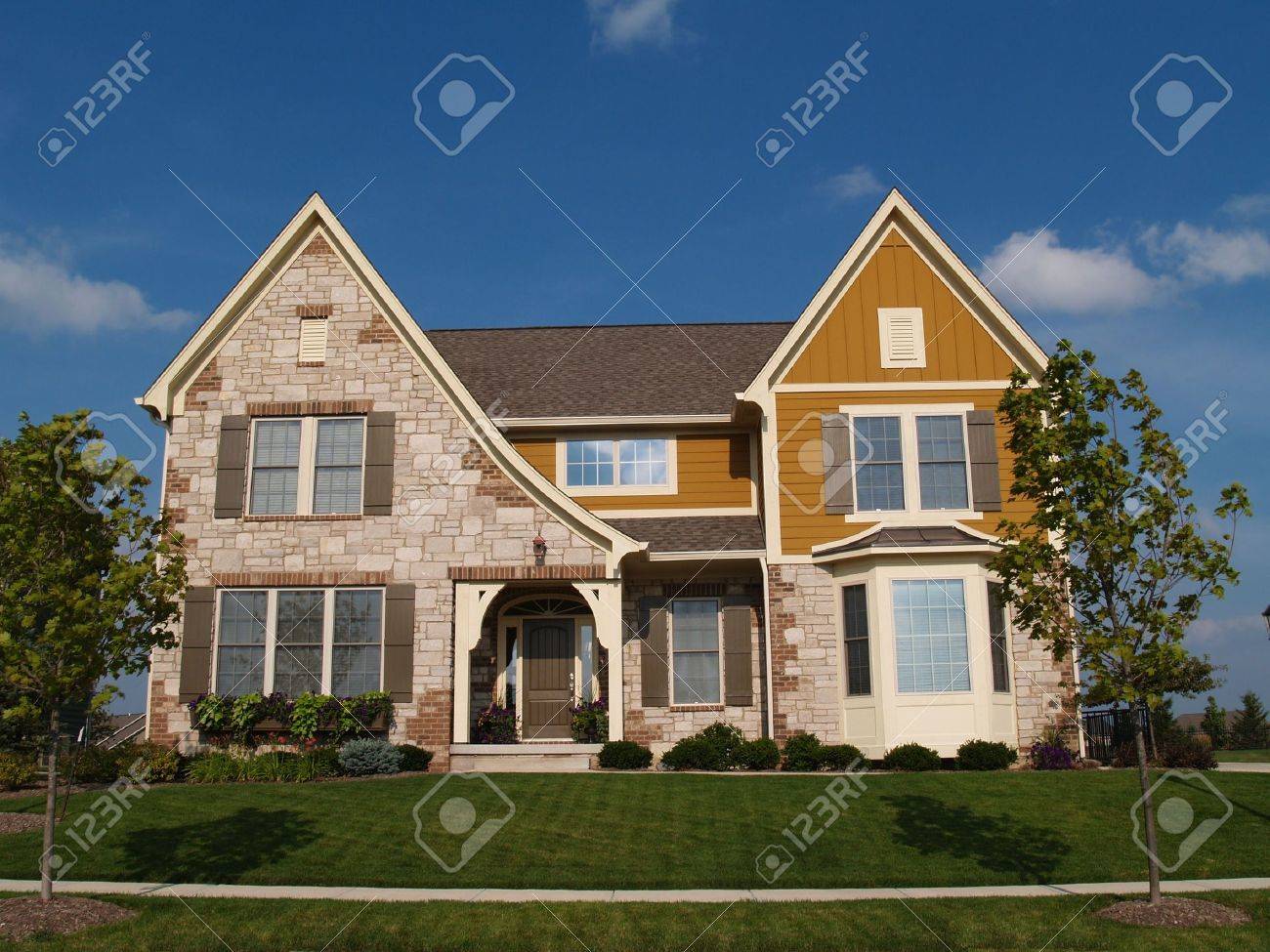 Two story stone, brick and board sided residential home with bay window. - 5458651 Two story stone, brick and board sided residential home with bay window. - 5458651