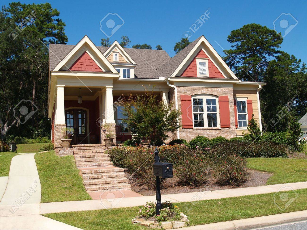 Beige brick home having peach and white trim with steps leading up to squares columns on the porch. - 6511098 Beige brick home having peach and white trim with steps leading up to squares columns on the porch. - 6511098