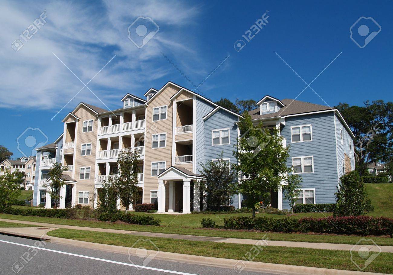 Three story condos, apartments or townhomes with vinyl siding of blue and tan. - 6386310 Three story condos, apartments or townhomes with vinyl siding of blue and tan. - 6386310
