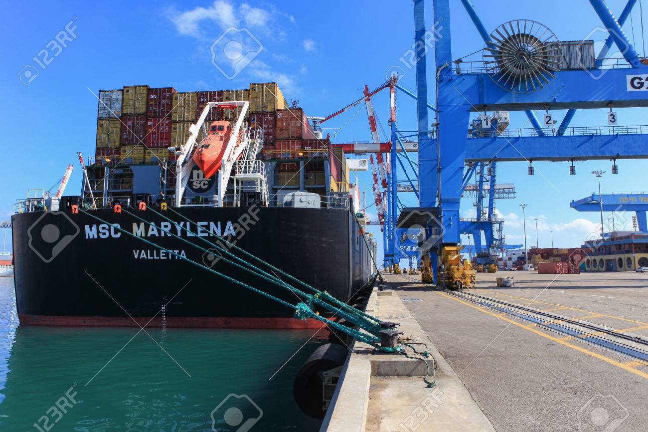 Port Dock With Container Ship And Various Brands Colors Of Shipping Containers Stacked In A Port Dock With Container Ship And Various Brands Colors Of Shipping Containers Stacked In A