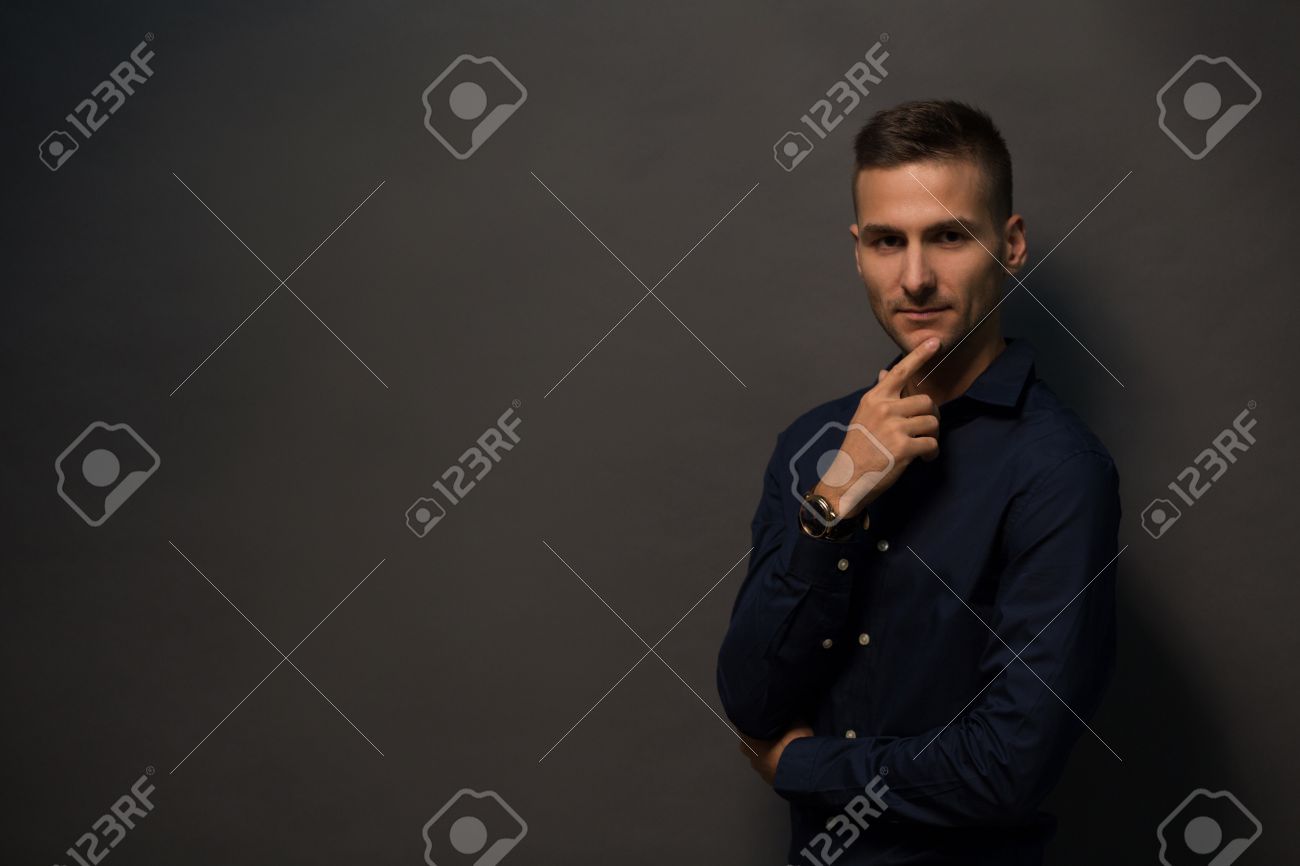 Cheerful Man With Short Haircut Touching His Bearded Face And