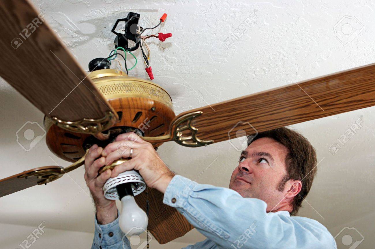 An Electrician Removing Old Ceiling Fan The Was Installed An Electrician Removing Old Ceiling Fan The Was Installed Without A Box