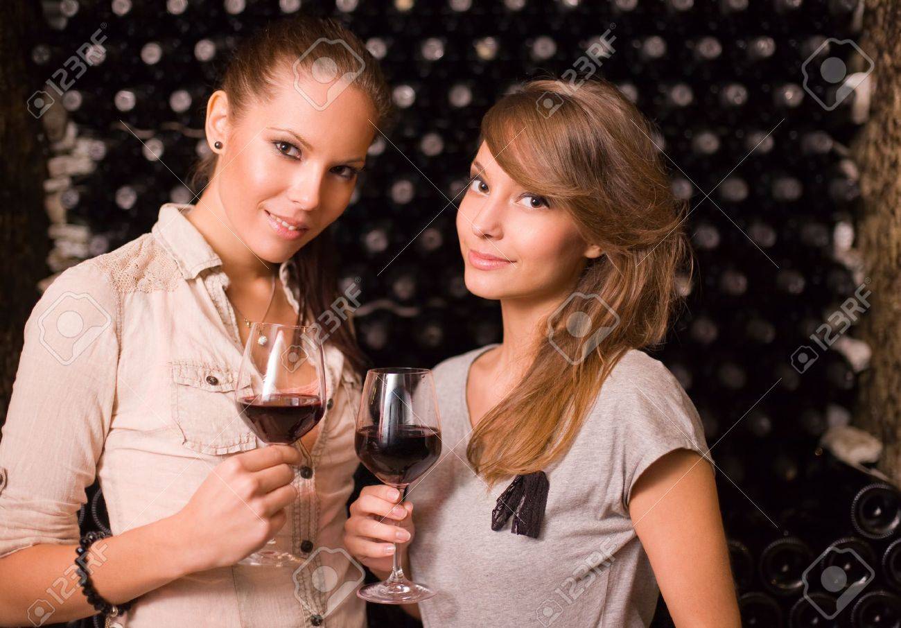 Portrait Of Two Beautiful Brunette Women Tasting Red Wine In The Cellar.  Stock Photo, Picture and Royalty Free Image. Image 11266955., image size:1300x906