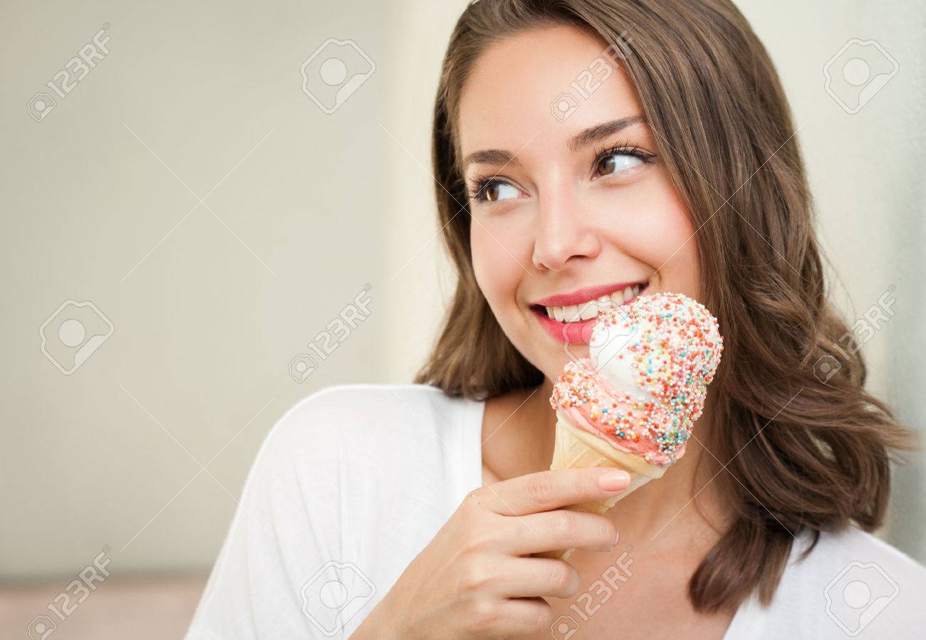Portrait of a gorgeous happy brunette woman having summer ice cream fun. - 45233770 Portrait of a gorgeous happy brunette woman having summer ice cream fun. - 45233770