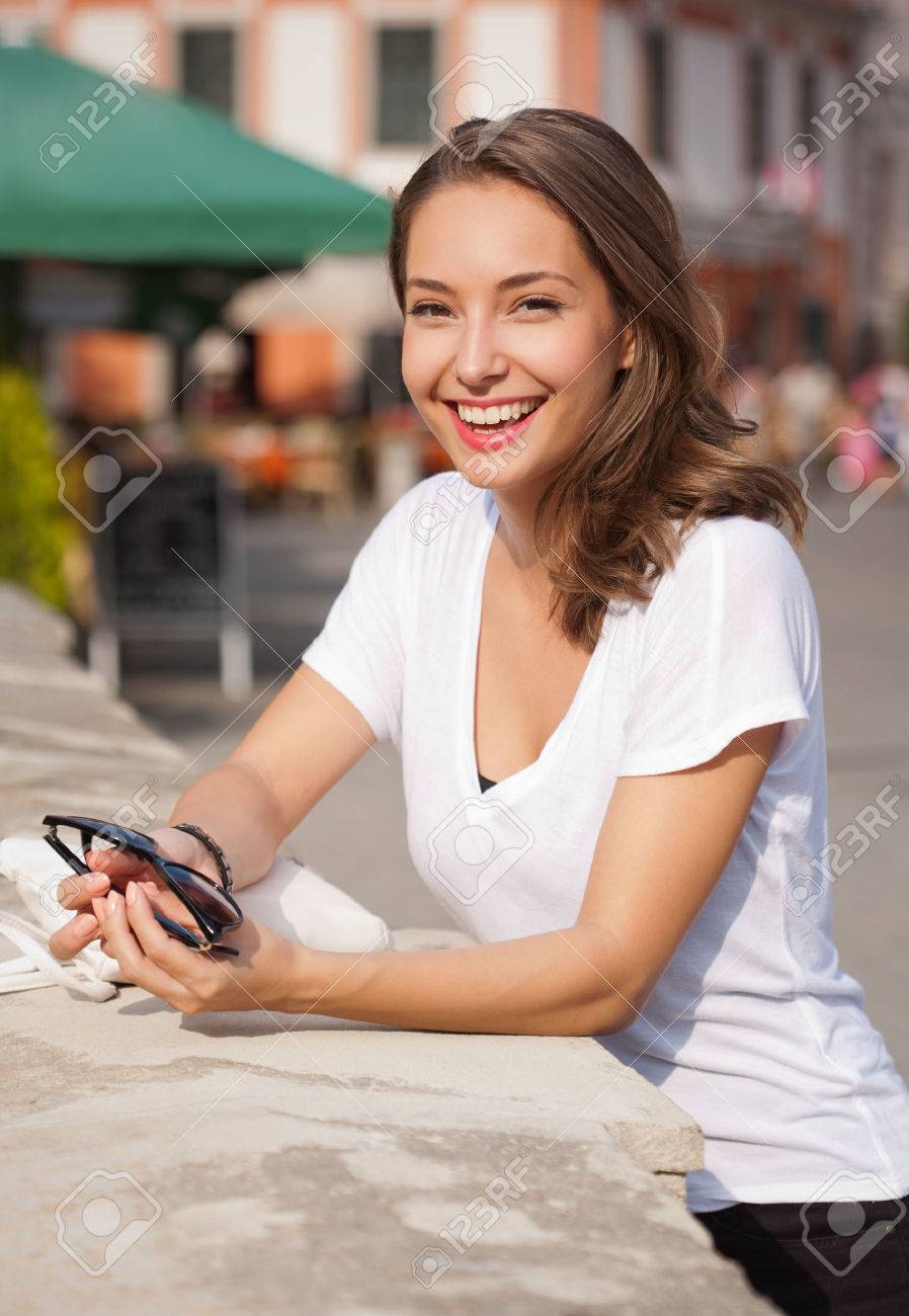 Portrait of a young brunette tourist woman taking photos. - 46512760 Portrait of a young brunette tourist woman taking photos. - 46512760