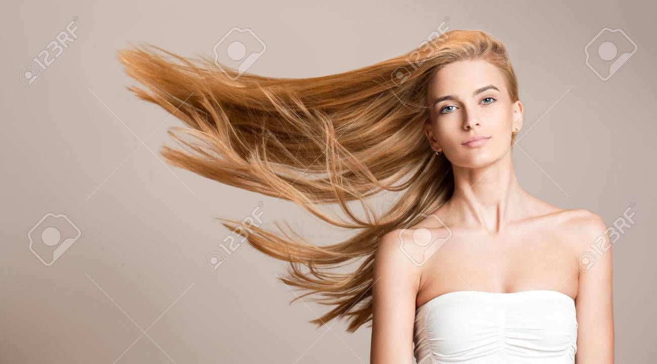 Portrait of a beautiful young blond woman with amazing flowing hair. - 52411007 Portrait of a beautiful young blond woman with amazing flowing hair. - 52411007
