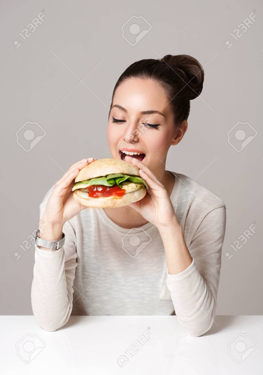 Portrait of a gorgeous young brunette woman showing diet food choices. - 53682847 Portrait of a gorgeous young brunette woman showing diet food choices. - 53682847