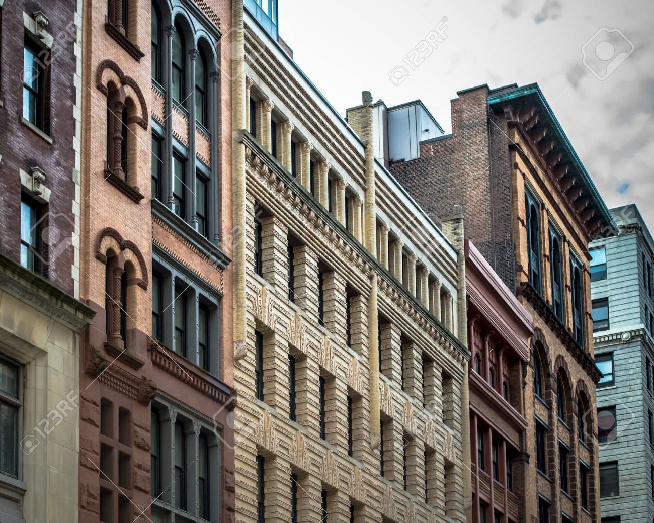 row of vintage new york city apartment buildings in a variety