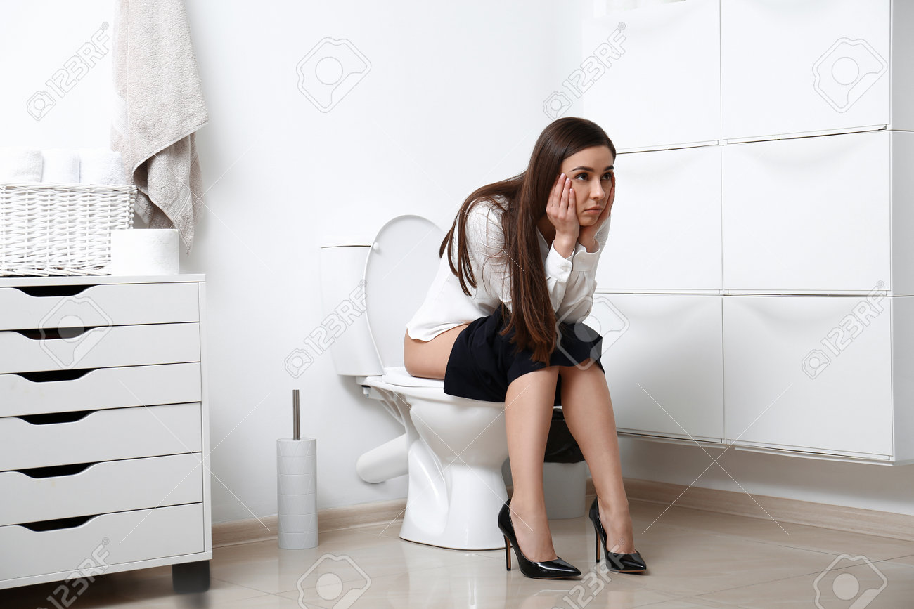 Upset Woman Sitting On Toilet Bowl In Bathroom Stock Photo, Picture and  Royalty Free Image. Image 197144116., image size:1300x867