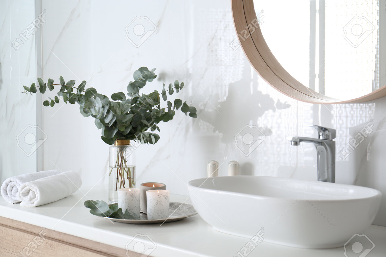 eucalyptus in vase in bathroom