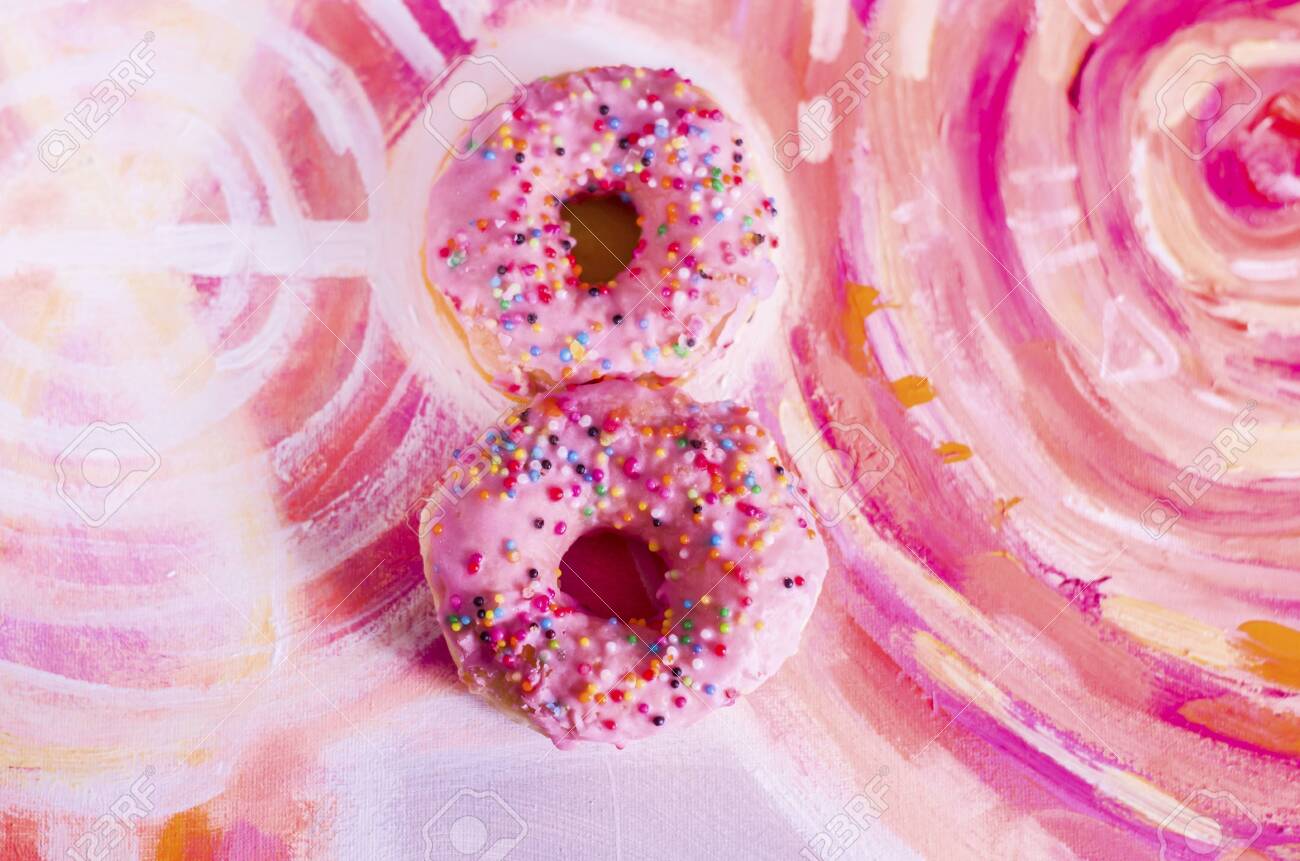 Pink Donuts in the form of 8 in a picturesque background. The International Women's Day. - 120025637 Pink Donuts in the form of 8 in a picturesque background. The International Women's Day. - 120025637