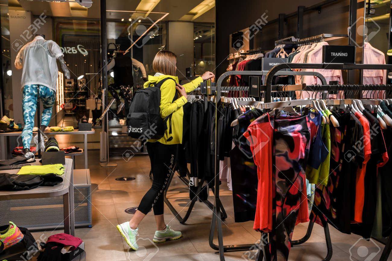 Skopje, North Macedonia - March 12, 2021: Asics store in Skopje, North Macedonia. Girl photo model wearing sports tracksuits and sneakers ASICS GEL, carrying a sports backpack on her shoulder - 166241078 Skopje, North Macedonia - March 12, 2021: Asics store in Skopje, North Macedonia. Girl photo model wearing sports tracksuits and sneakers ASICS GEL, carrying a sports backpack on her shoulder - 166241078